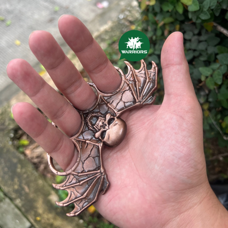 Manopla calavera alas cobre